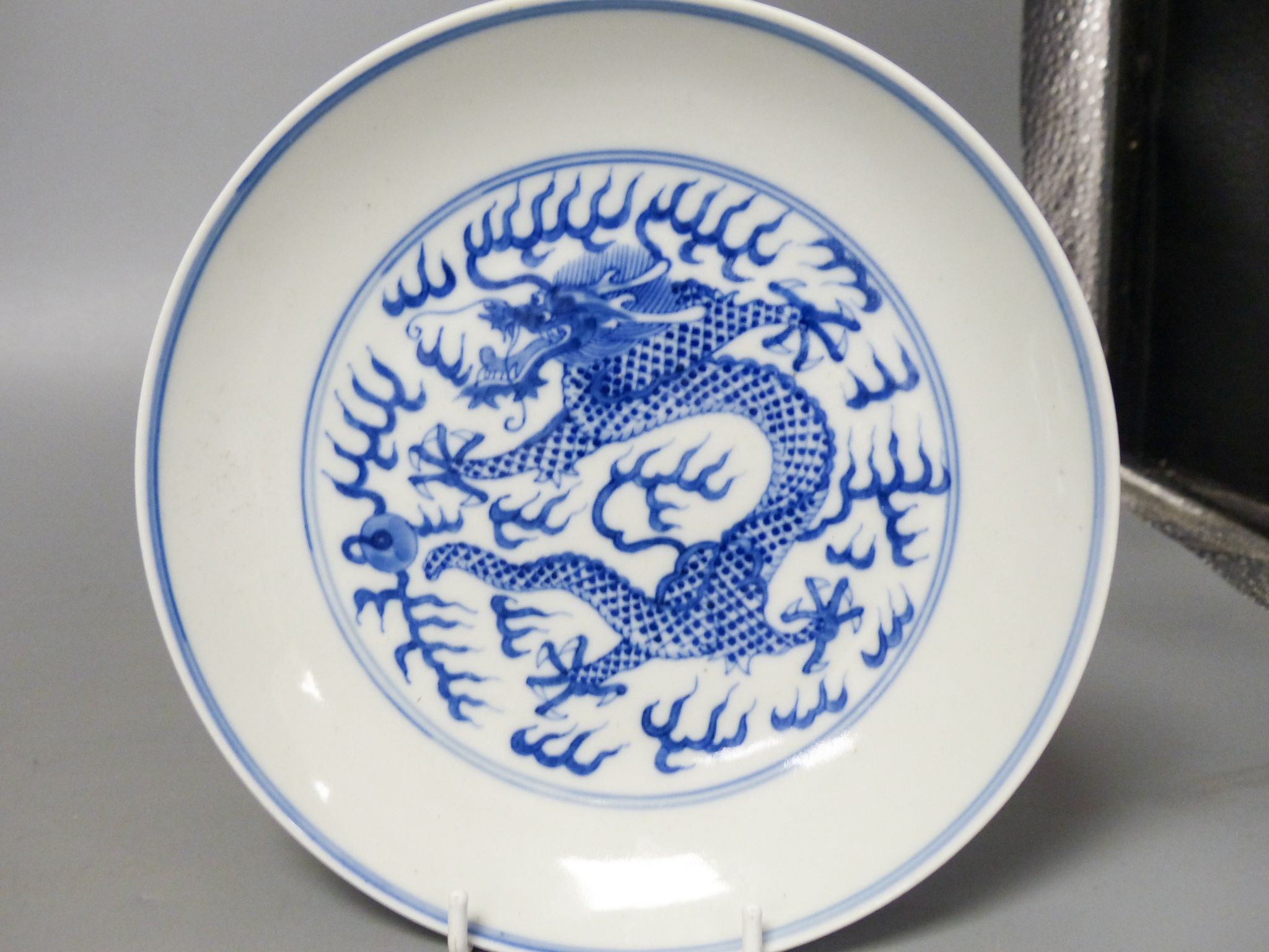 A Chinese blue and white landscape bowl, a/f and a Chinese blue and white ‘dragon’ dish, 18 and 16.5 cm